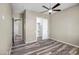 Comfortable bedroom with wood-look floors and an open closet with shelving at 23408 W Barwick Dr, Wittmann, AZ 85361