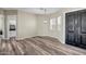 Dining area featuring wood-look floors, neutral walls, and a modern chandelier at 23408 W Barwick Dr, Wittmann, AZ 85361