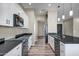 Modern kitchen featuring stainless steel appliances, white cabinets, and an island sink at 23408 W Barwick Dr, Wittmann, AZ 85361