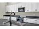 Kitchen featuring granite countertops, stainless steel appliances, and white cabinets at 23408 W Barwick Dr, Wittmann, AZ 85361