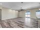 Spacious living room with wood-look floors and large sliding glass doors at 23408 W Barwick Dr, Wittmann, AZ 85361