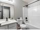 Well-lit bathroom with a shower and bathtub combination featuring white tile at 23420 N 121St Ave, Sun City, AZ 85373