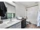 Bathroom with vanity, modern sink, and combination shower and tub at 23420 N 121St Ave, Sun City, AZ 85373