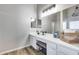 Bright bathroom vanity with double sinks, spacious countertop, and modern lighting at 23420 N 121St Ave, Sun City, AZ 85373