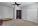 Bedroom featuring neutral carpet, a ceiling fan, and a closet with sliding doors at 23420 N 121St Ave, Sun City, AZ 85373