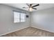 Bedroom with neutral walls and carpet and a large window at 23420 N 121St Ave, Sun City, AZ 85373