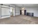 Spacious carpeted bedroom with sliding barn door, chest of drawers, and modern ceiling fan at 23420 N 121St Ave, Sun City, AZ 85373