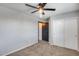 This bedroom features neutral walls, carpet, ceiling fan and closet at 23420 N 121St Ave, Sun City, AZ 85373