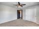 This bedroom features neutral walls, carpet, ceiling fan and closet at 23420 N 121St Ave, Sun City, AZ 85373