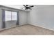 Bedroom with neutral walls and carpet with a large window with blinds at 23420 N 121St Ave, Sun City, AZ 85373