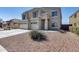 Inviting two-story home featuring a three-car garage and landscaped front yard for added curb appeal at 23420 N 121St Ave, Sun City, AZ 85373