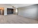 Living room with carpet, ceiling fan, recessed lighting, and wall shelves at 23420 N 121St Ave, Sun City, AZ 85373