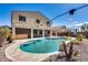 Private pool area surrounded by rock with home in the background at 23420 N 121St Ave, Sun City, AZ 85373