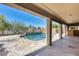 Covered view of the private pool area with travertine pavers at 23420 N 121St Ave, Sun City, AZ 85373