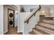 Staircase with hardwood treads, leading to the upper level, next to a laundry area at 23420 N 121St Ave, Sun City, AZ 85373