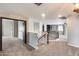 Upper landing featuring carpet, a wrought iron railing, and access to multiple rooms at 23420 N 121St Ave, Sun City, AZ 85373
