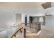 Bright upper landing with wrought iron railing, with carpet and a view to a secondary living area at 23420 N 121St Ave, Sun City, AZ 85373