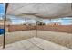 Low-maintenance backyard with gravel landscaping, covered patio, and block wall fencing at 24009 W Antelope Trl, Buckeye, AZ 85326