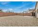 Spacious backyard featuring gravel landscaping, a covered patio, and privacy fencing at 24009 W Antelope Trl, Buckeye, AZ 85326