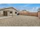 The backyard is landscaped with gravel with a covered patio and block fence at 24009 W Antelope Trl, Buckeye, AZ 85326