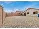 Low-maintenance backyard with gravel landscaping, a covered patio, and block wall fencing at 24009 W Antelope Trl, Buckeye, AZ 85326