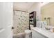 Bathroom featuring a shower/tub combo with printed curtain, vanity with sink, and shelf storage at 24009 W Antelope Trl, Buckeye, AZ 85326