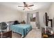 Cozy bedroom features a ceiling fan, neutral walls, and a window with natural light at 24009 W Antelope Trl, Buckeye, AZ 85326