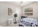 Bright bedroom with blue and white quilt, window, closet, fan, and personal decor at 24009 W Antelope Trl, Buckeye, AZ 85326