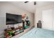 Comfortable bedroom with a television, ceiling fan, and a closet at 24009 W Antelope Trl, Buckeye, AZ 85326