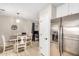 Cozy dining area adjacent to the kitchen with tile floors and modern pendant lighting at 24009 W Antelope Trl, Buckeye, AZ 85326