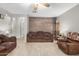 Open living room with tile floors, neutral walls, a wood accent wall, and ceiling fan at 24009 W Antelope Trl, Buckeye, AZ 85326