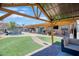Backyard patio with built in water feature, patio furniture and artificial turf at 2727 W Libby St, Phoenix, AZ 85053