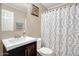 Cozy bathroom featuring a stylish vanity, white toilet, and shower with a patterned curtain at 2727 W Libby St, Phoenix, AZ 85053