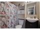 Cozy bathroom with a vanity and a toilet with decorative shower curtain at 2727 W Libby St, Phoenix, AZ 85053
