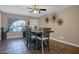 A charming dining area is illuminated by a modern ceiling fan and features an eye-catching wall decor at 2727 W Libby St, Phoenix, AZ 85053