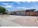 Wide driveway featuring desert landscaping, unique brickwork, and ample parking space at 2727 W Libby St, Phoenix, AZ 85053