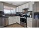 Well-equipped kitchen features stainless steel appliances, white cabinets, and granite countertops for a modern touch at 2727 W Libby St, Phoenix, AZ 85053