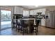 Open-concept kitchen with granite countertops, white cabinetry, and a breakfast bar with seating at 2727 W Libby St, Phoenix, AZ 85053