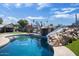 Backyard with slide and large pool surrounded by artificial turf at 2727 W Libby St, Phoenix, AZ 85053