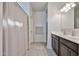 Bathroom with a shower curtain, dark vanity, and tile flooring at 30935 W Mulberry Dr, Buckeye, AZ 85396