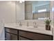 Bathroom with double sinks, dark cabinets, and large mirror at 30935 W Mulberry Dr, Buckeye, AZ 85396