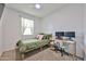 Cozy bedroom featuring a ceiling fan and dedicated workspace with desk and monitor setup at 30935 W Mulberry Dr, Buckeye, AZ 85396