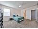 Bedroom with carpet, ceiling fan and area rug, leading to bathroom and hallway at 30935 W Mulberry Dr, Buckeye, AZ 85396