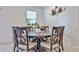 Cozy dining room featuring a large wooden table, seating for six and natural light from a window at 30935 W Mulberry Dr, Buckeye, AZ 85396