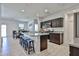 Bright, open kitchen with granite countertops, stainless steel appliances, and a central island at 30935 W Mulberry Dr, Buckeye, AZ 85396