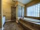 Spa-like bathroom with glass block window, separate tub, and shower at 3840 E San Mateo Way, Chandler, AZ 85249