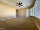 Bright bedroom with a ceiling fan, natural light and an open door to the outside at 3840 E San Mateo Way, Chandler, AZ 85249