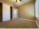 Cozy bedroom with neutral carpet, ceiling fan, and a closet with sliding doors at 3840 E San Mateo Way, Chandler, AZ 85249