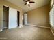 Comfortable bedroom with neutral carpet, ceiling fan, closet, and natural light at 3840 E San Mateo Way, Chandler, AZ 85249