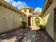 Covered walkway leads to a wooden door with decorative desert landscaping at 3840 E San Mateo Way, Chandler, AZ 85249